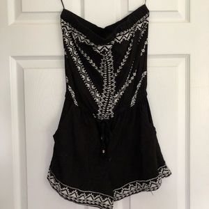 Black strapless embroidered romper.